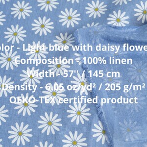 medium weight linen fabric light blue with small white floral daisy pattern close up