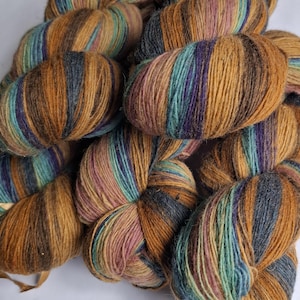 Wool yarn for knitting. High quality multicolor  old pink , blue, rust orange striped 100% wool yarn. Natural lanolin yarn.