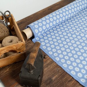 blue linen fabric with white chamomile daisy print single sided natural back side