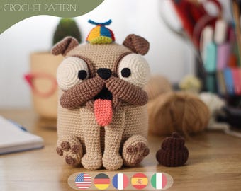 May include: A crocheted pug dog with a colorful hat and a small brown crocheted poop. The pug has large, round eyes, a brown snout, and a pink tongue. The text "CROCHET PATTERN" is at the top of the image.