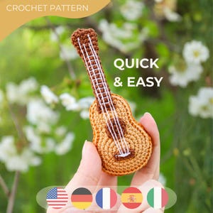 May include: A crocheted ukulele in shades of brown and tan, with white strings. The text "QUICK & EASY" is displayed. The words "CROCHET PATTERN" are at the top. The image includes flags of different countries.