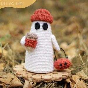 May include: A handmade crochet ghost figure wearing a rust-colored hat, holding a small cup and a jack-o'-lantern bucket. The ghost has black eyes and is standing on a wooden base. The words "CROCHET PATTERN" are in the upper left corner.