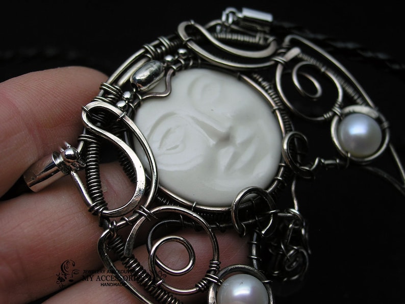 Pendant-talismn Lunnitsa Jewelry-amulet with pearls and ceramic cabochon in the shape of the face of the moon Pendant in Victorian style.