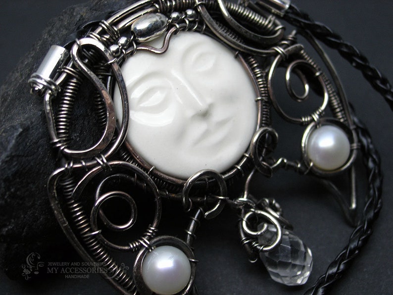 Pendant-talismn Lunnitsa Jewelry-amulet with pearls and ceramic cabochon in the shape of the face of the moon Pendant in Victorian style.