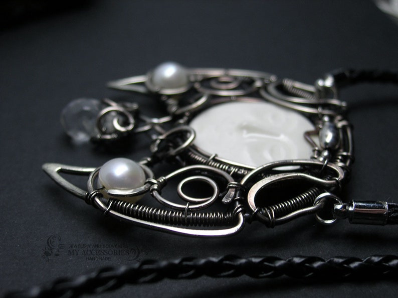 Pendant-talismn Lunnitsa Jewelry-amulet with pearls and ceramic cabochon in the shape of the face of the moon Pendant in Victorian style.