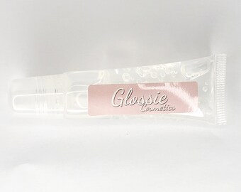 May include: A clear plastic tube with a label that says "Glossie Cosmetics".