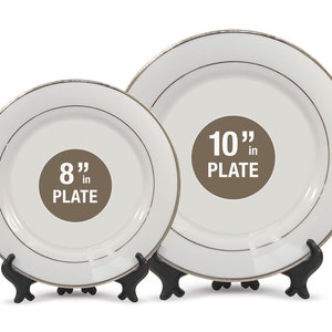 May include: Two white plates with gold trim, one 8 inches and the other 10 inches in diameter, are displayed on black stands. The plates have a simple, elegant design, suitable for various occasions.