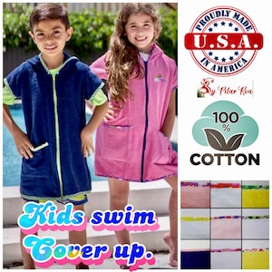 May include: Two children wearing hooded towels, one blue and one pink, with the text "Kids swim Cover up."  The towels are made of 100% cotton and are proudly made in the USA. A variety of colorful towels are shown in the bottom right corner.