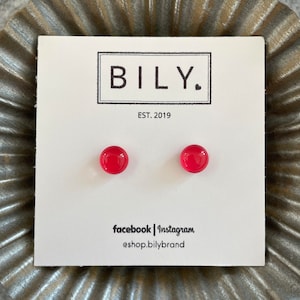 May include: A pair of red glass stud earrings on a white card with the text "BILY. EST. 2019" and "facebook | instagram @shop.bilybrand".