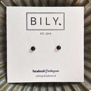 May include: A pair of black stud earrings displayed on a white card with the text "BILY. EST. 2019" and "facebook | Instagram @shop.bilybrand".