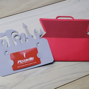 May include: A gray card shaped like a toolbox with tool silhouettes, holding a red gift card. A red toolbox-shaped card is next to it. The gift card reads "Pizzaville" and "Stone Baked Pizza".