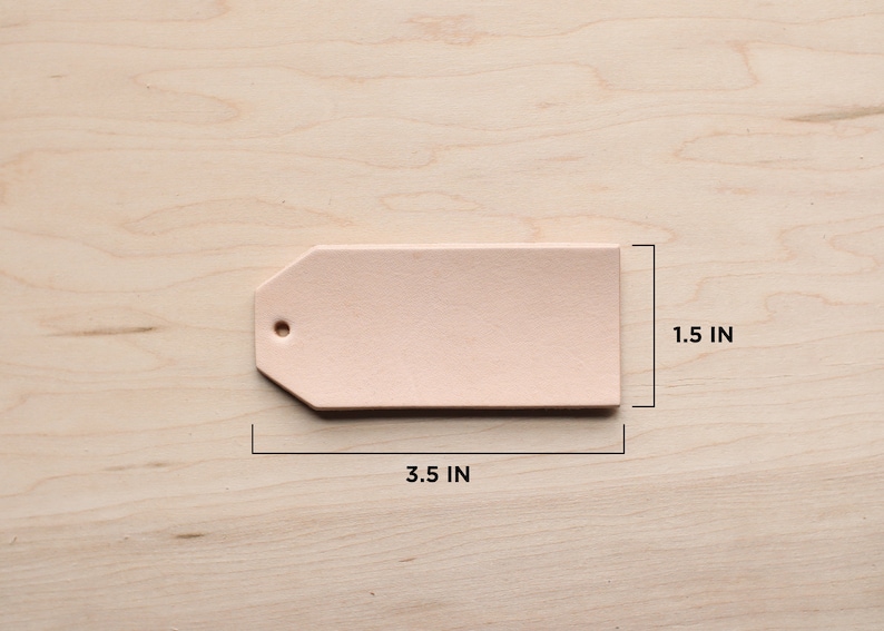 May include: A light pink leather tag with a hole in the top. The tag is 3.5 inches wide and 1.5 inches tall.