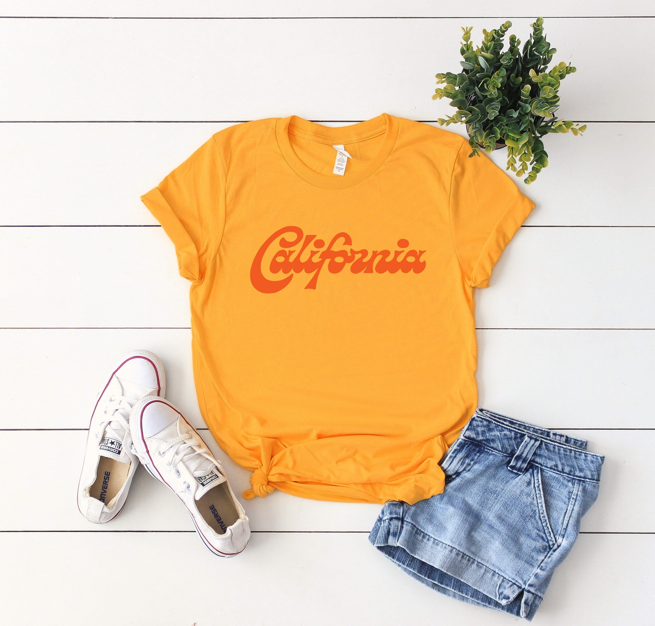 RE/DONE | T-shirt California Surfing Snoopy bianca – lemlò RE/DONE | T-shirt California Surfing Snoopy bianca – lemlò