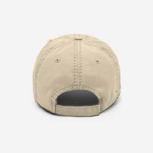 May include: A beige baseball cap with a curved brim and a mesh back. The cap is made of a soft, comfortable fabric and has a classic, timeless design.