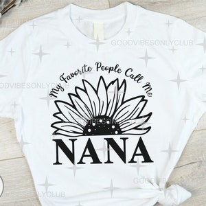 May include: White t-shirt with a black sunflower graphic and the text "My Favorite People Call Me Nana".