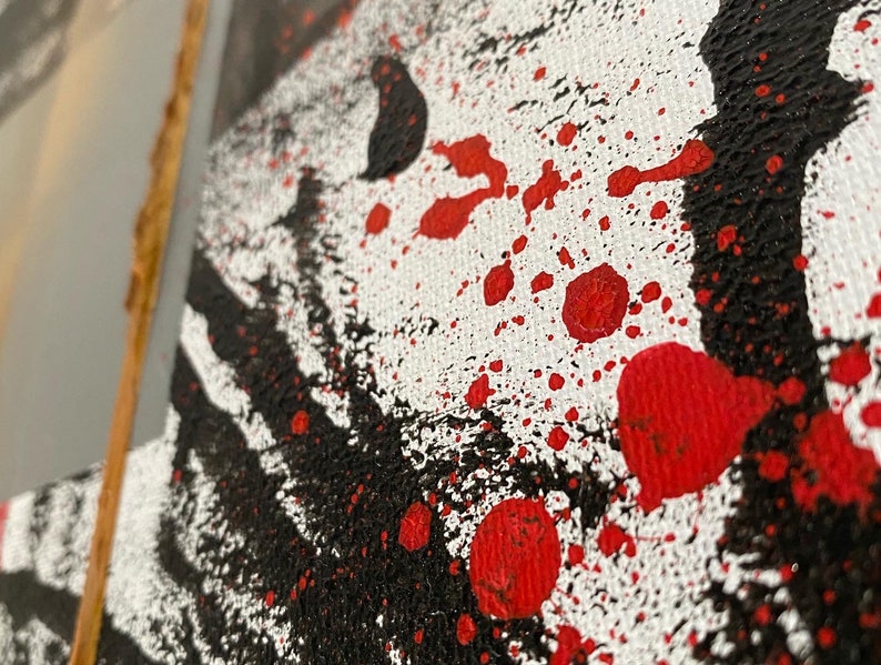 May include: Abstract art painting with black and red paint splatters on a white canvas.