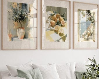 May include: Three framed watercolor prints depicting botanical and coastal scenes. The prints feature a vase with a plant, lemons on a table, and a coastal view through a window. The frames are light-colored wood, and the overall aesthetic is bright and airy.