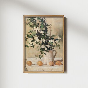 Vintage flowers and lemons art print reproduction featuring a classic floral citrus still life composition. The artwork shows delicate flowers paired with bright lemons in a timeless arrangement, rendered in soft natural tones with traditional painterly detail. This vintage still life wall art is ideal for kitchen decor, dining rooms, and elegant homes inspired by European, Mediterranean, or classic farmhouse style.