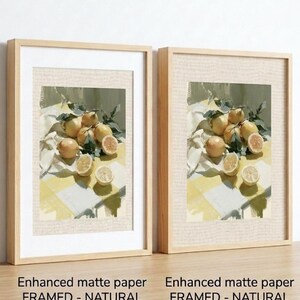 May include: Two framed art prints featuring a still life of lemons. The artwork depicts whole and sliced lemons with green leaves on a yellow and white checkered surface. The frames are natural wood with white mats. Text reads: Enhanced matte paper FRAMED - NATURAL with MAT.
