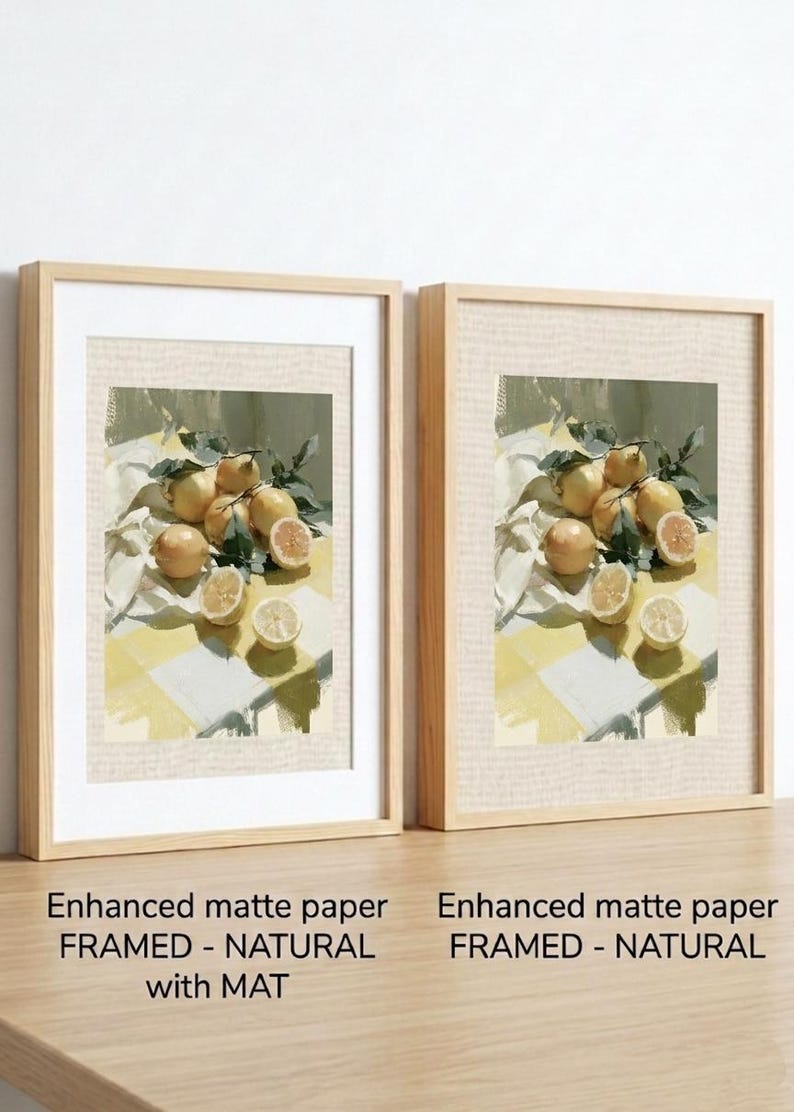 May include: Two framed art prints featuring a still life of lemons. The artwork depicts whole and sliced lemons with green leaves on a yellow and white checkered surface. The frames are natural wood with white mats. Text reads: Enhanced matte paper FRAMED - NATURAL with MAT.
