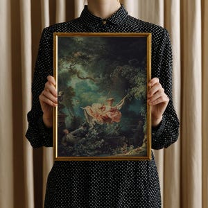 Woman holding Fragonard The Swing giclée art print in gold float frame, size reference scale photo, Jean-Honoré Fragonard 1767 French Rococo painting reproduction, romantic classical art gift for art history lover