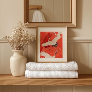 Red and white Japanese cranes in flight illustrated in a traditional Asian art style on a vibrant red background. Framed or unframed wall art.
