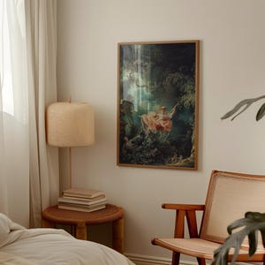 Fragonard The Swing L'Escarpolette 1767 French Rococo art print, natural oak wood float frame, hung on cream wall above white linen bed, wicker rattan table lamp cane armchair, romantic chateaucore bedroom wall decor
