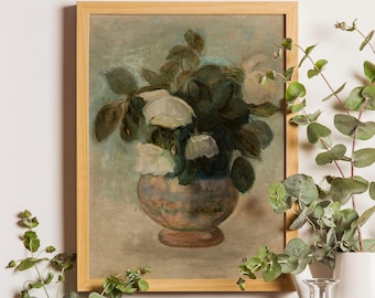 May include: A framed painting depicting a bouquet of white roses in a rounded, multi-colored vase. The artwork features muted green and brown tones with visible brushstrokes, set within a simple light-colored wooden frame.