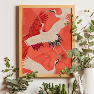 Red and white Japanese cranes in flight illustrated in a traditional Asian art style on a vibrant red background. Framed or unframed wall art.