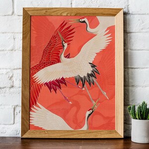 Red and white Japanese cranes in flight illustrated in a traditional Asian art style on a vibrant red background. Framed or unframed wall art.