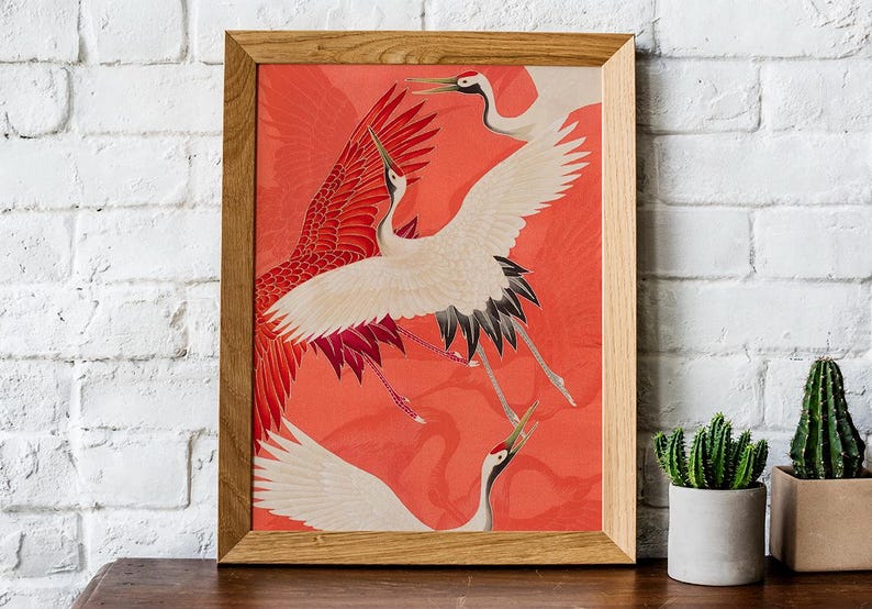 Red and white Japanese cranes in flight illustrated in a traditional Asian art style on a vibrant red background. Framed or unframed wall art.