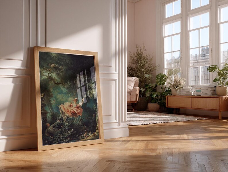 Fragonard The Swing Jean-Honoré Fragonard French Rococo art print, large natural oak float frame, leaning in bright Parisian Haussmann living room, monstera indoor plant oak mid-century sideboard stacked books, romantic maximalist living room wall decor