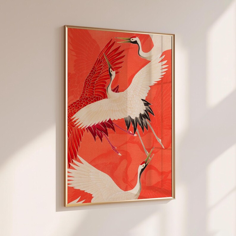 Red and white Japanese cranes in flight illustrated in a traditional Asian art style on a vibrant red background. Framed or unframed wall art.