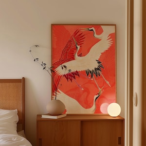 Red and white Japanese cranes in flight illustrated in a traditional Asian art style on a vibrant red background. Framed or unframed wall art.