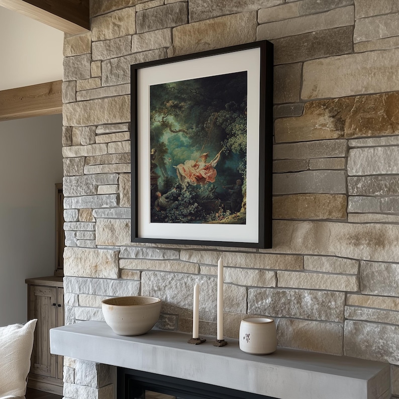 Fragonard The Swing L'Escarpolette Rococo painting giclée print, slim black frame white mat, mounted on rustic natural stone fireplace chimney breast, white ceramic bowl taper candles, dark academia farmhouse living room wall art