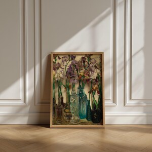 ramed vintage flower wall art print displayed in a cozy interior setting, reproduced from Frederick Judd Waugh’s 1922 Rum Row floral still life. The botanical artwork features classic early twentieth-century style with natural colors and refined detail, ideal for cottagecore, traditional, or antique-inspired home decor.