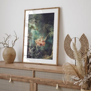 Fragonard The Swing Jean-Honoré Fragonard Rococo art print, natural oak wood frame white mat, leaning on rattan cane sideboard, ceramic vase dried branches pampas grass wicker sculptural moon decor, boho cottagecore romantic French wall art