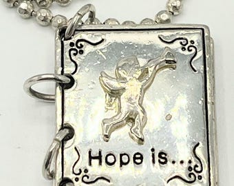 Silver tone necklace with book pendant