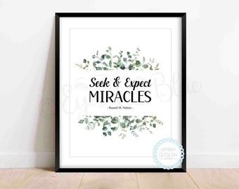 May include: A black framed print with a white background and a quote that reads "Seek & Expect Miracles - Russell M. Nelson -" with a watercolor illustration of green leaves and branches.