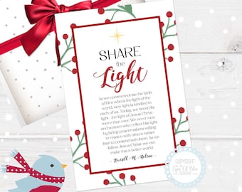 May include: A white card with a red border and green holly sprigs with red berries. The card has the text "SHARE the Light" in a large, decorative font. The text continues with a quote from Russell M. Nelson: "As we commemorate the birth of Him who is the light of the world, new light is kindled in each of us. Today, we need His light - the light of Jesus Christ - more than ever. We need men and women who reflect His light by being peacemakers willing to reason with others rather than to contend with them. As we follow Jesus Christ, we can make this a better world."