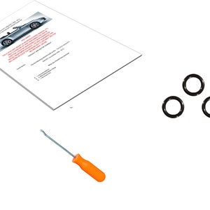 May include: An image featuring a car manual, four black O-rings, and a screwdriver with an orange handle. The manual has a car image and text. The items are on a white background.