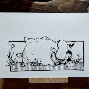 May include: Black and white ink drawing of a cartoon raccoon wearing a sleep mask and lying on its back in a grassy field.