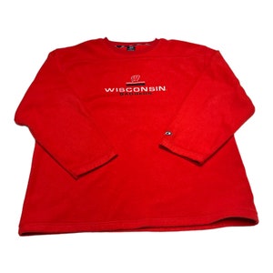 May include: Red long-sleeve fleece sweatshirt with the embroidered text "WISCONSIN BADGERS" and a Wisconsin Badgers logo.