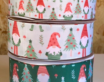 May include: Three rolls of green and white Christmas ribbon with a gnome and Christmas tree pattern.