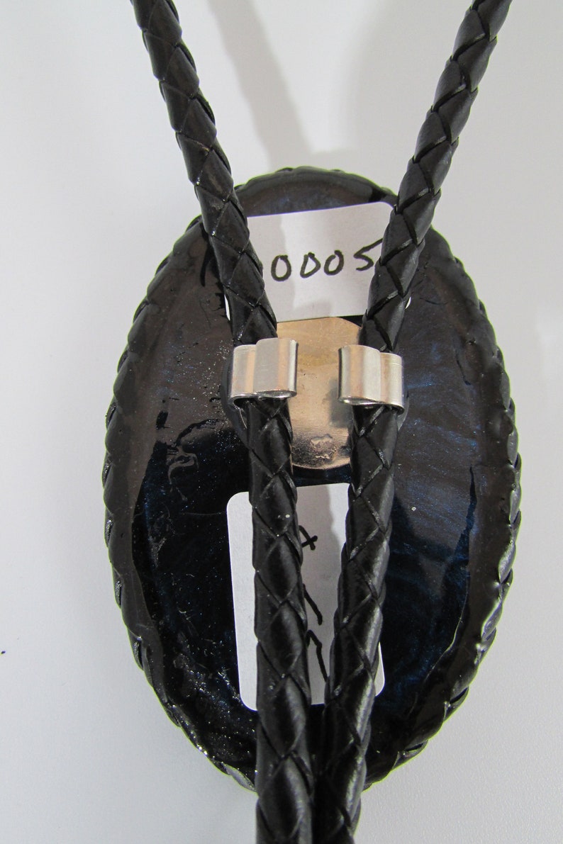 41 Authentic Arizona Bark Scorpion Bolo Tie on BlueBlack Swirl Background with Black Braided Leather Cording
