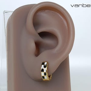 May include: Gold-tone hoop earring with a black and white chequered design. The earring is shown on a mannequin ear. The word "vanbelle" is in the upper right corner.