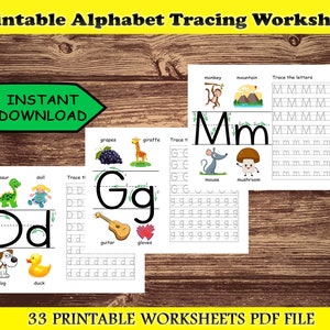 May include: A printable alphabet tracing worksheet with the text "Printable Alphabet Tracing Worksheet" and "INSTANT DOWNLOAD". The worksheet includes tracing letters, with illustrations of a monkey, mountain, grapes, giraffe, dinosaur, doll, dog, and duck.