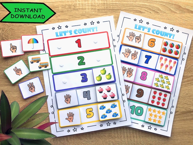 May include: Educational counting game with colorful illustrations. The game features cards with numbers 1-10, corresponding hand gestures, and images of objects like apples, cupcakes, and fish. The words "LET'S COUNT!" are displayed on the top of the game.