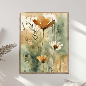 May include: Watercolor painting of flowers in a wooden frame. The artwork features orange and white flowers with green foliage against a backdrop of soft green and beige hues. The painting is displayed on a white wall above a chair.