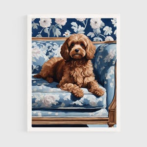 May include: A fluffy golden-brown dog with curly fur resting on a blue sofa featuring a white floral pattern. The dog is positioned in the center of the frame, facing forward, with its paws tucked underneath its body on the upholstered seat.